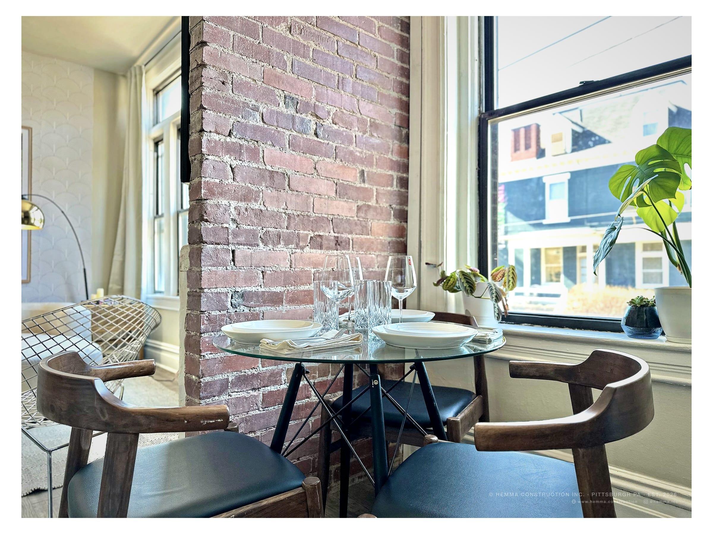 Dining area with panel moulding and room-specific wallpaper