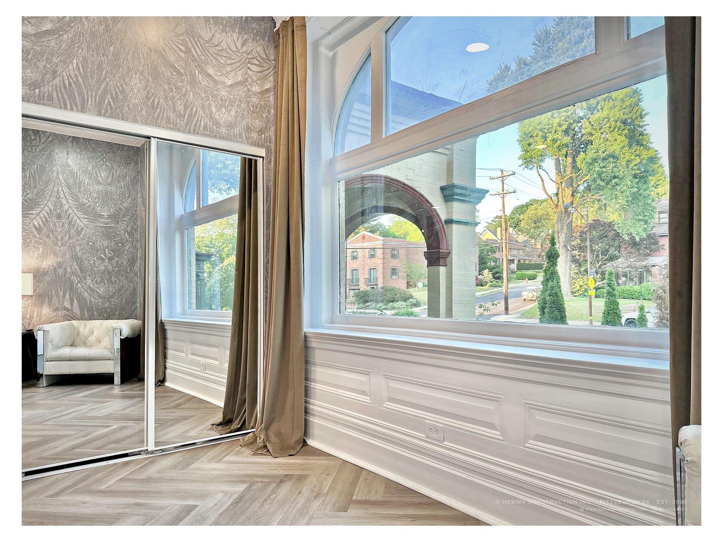 Bedroom window with arched street view and wardrobe mirror