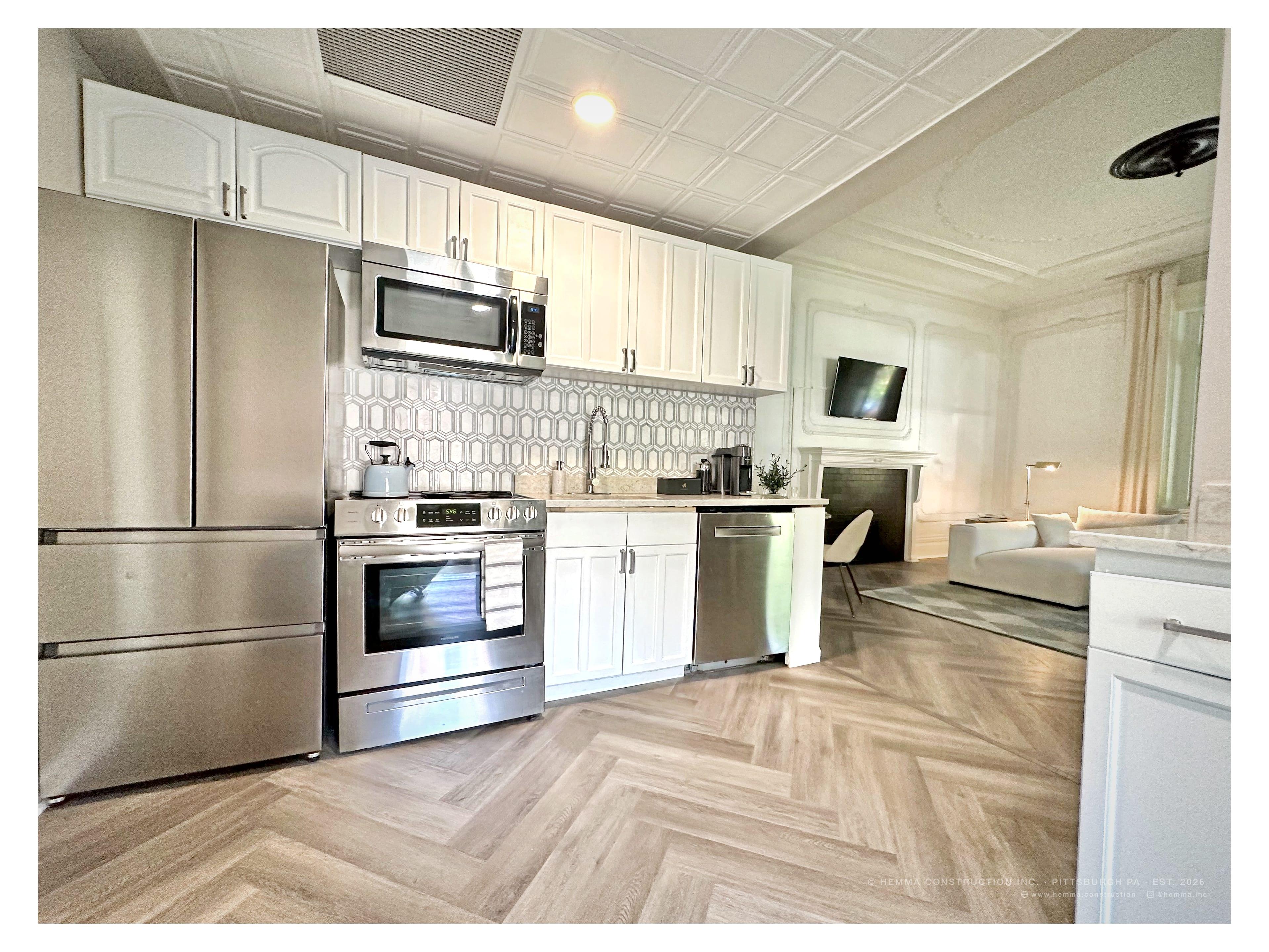 Kitchen — stainless appliances, herringbone tile floor