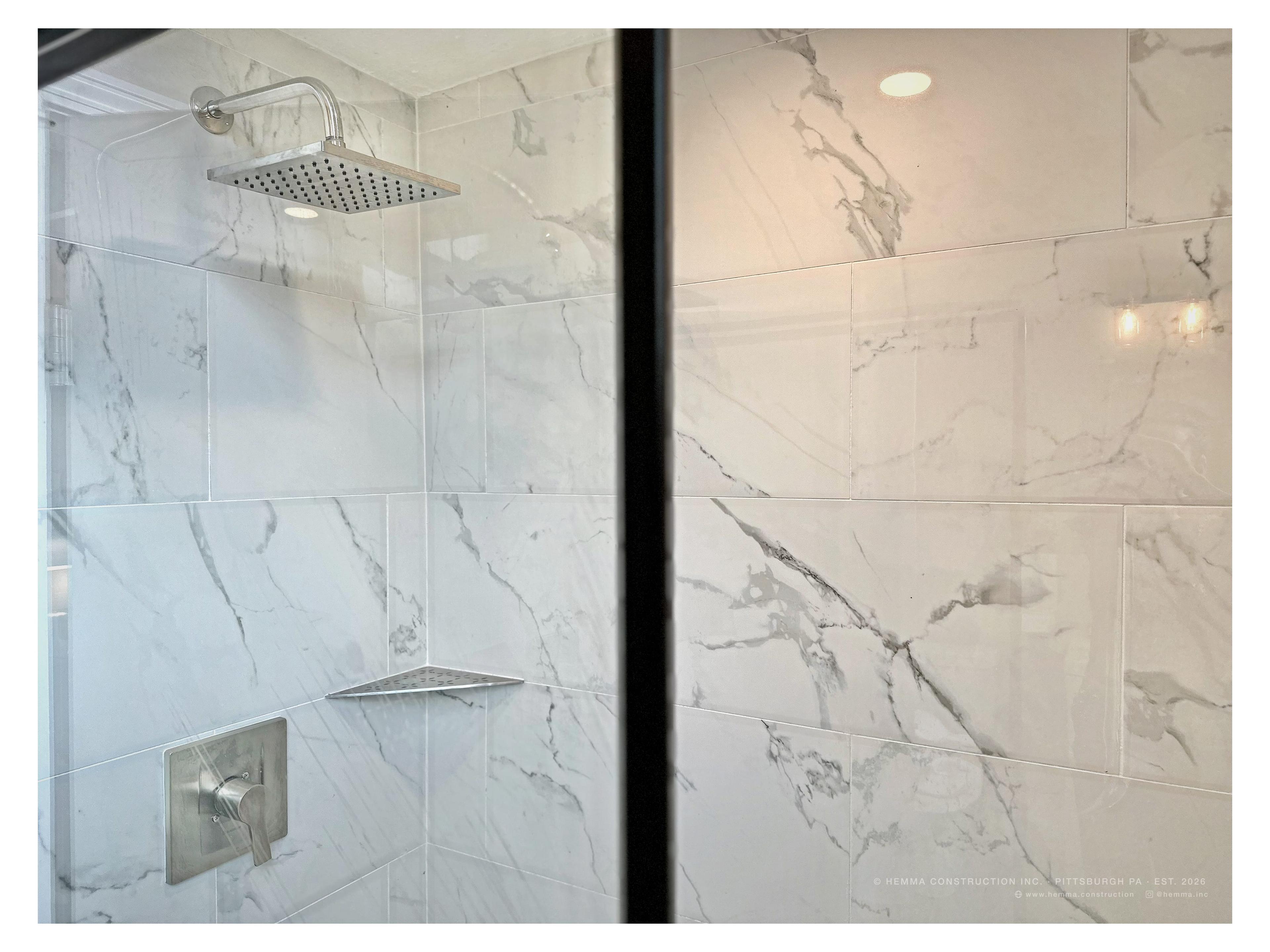 Bathroom shower — marble tile, rain head, glass enclosure