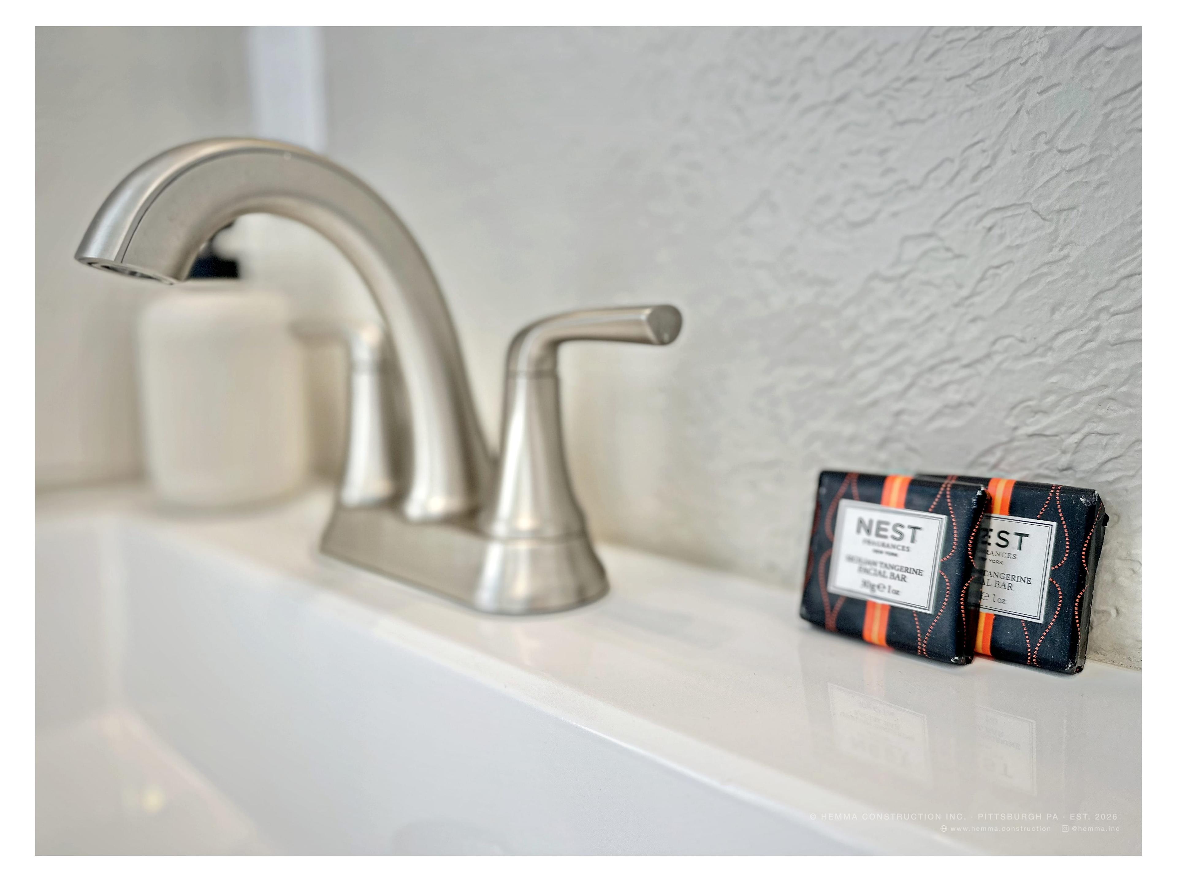 Bathroom vanity detail — Nest soap, brushed nickel faucet