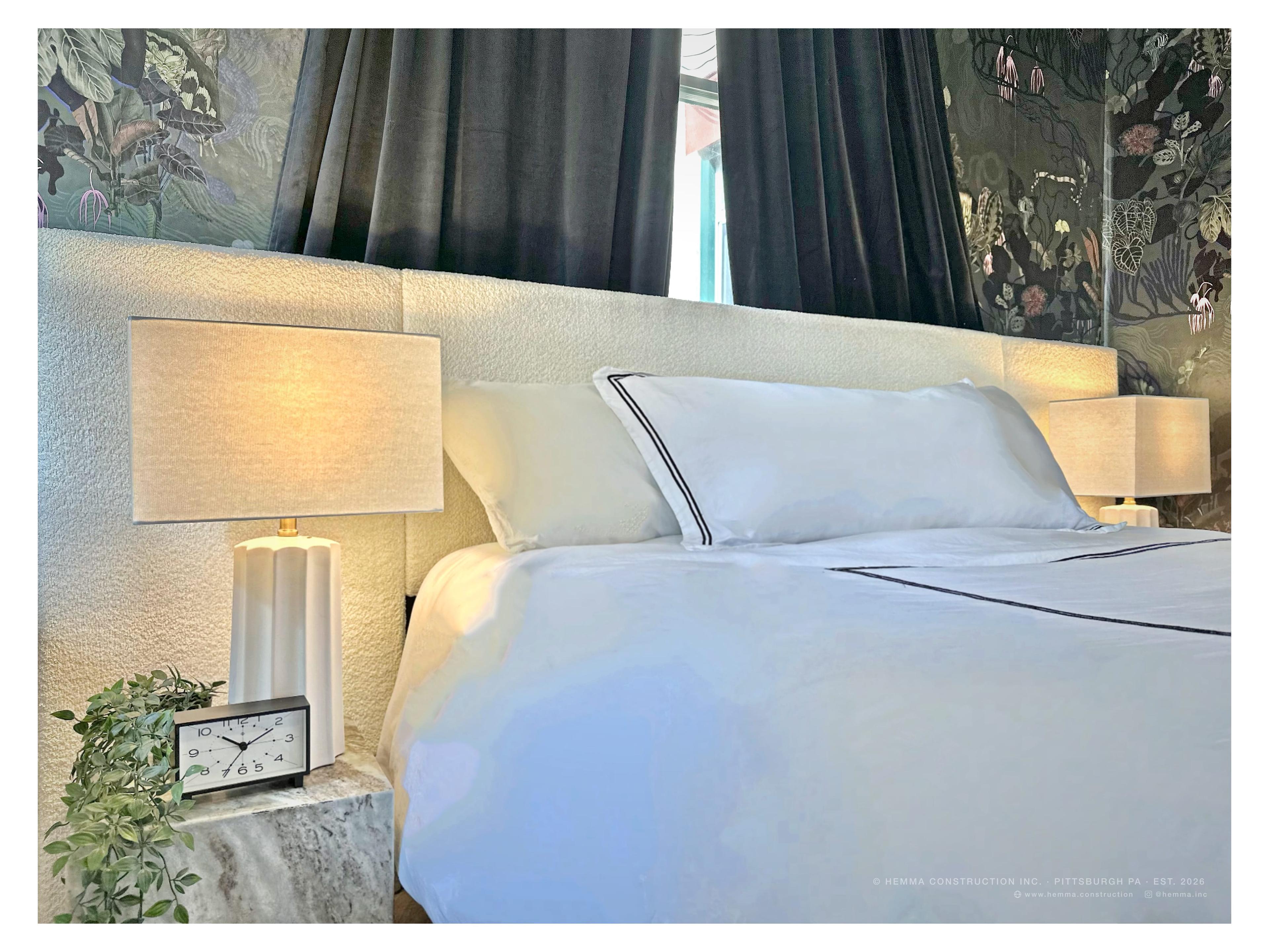 Bedroom — bouclé headboard, white hotel linen, paired lamps, botanical wallpaper