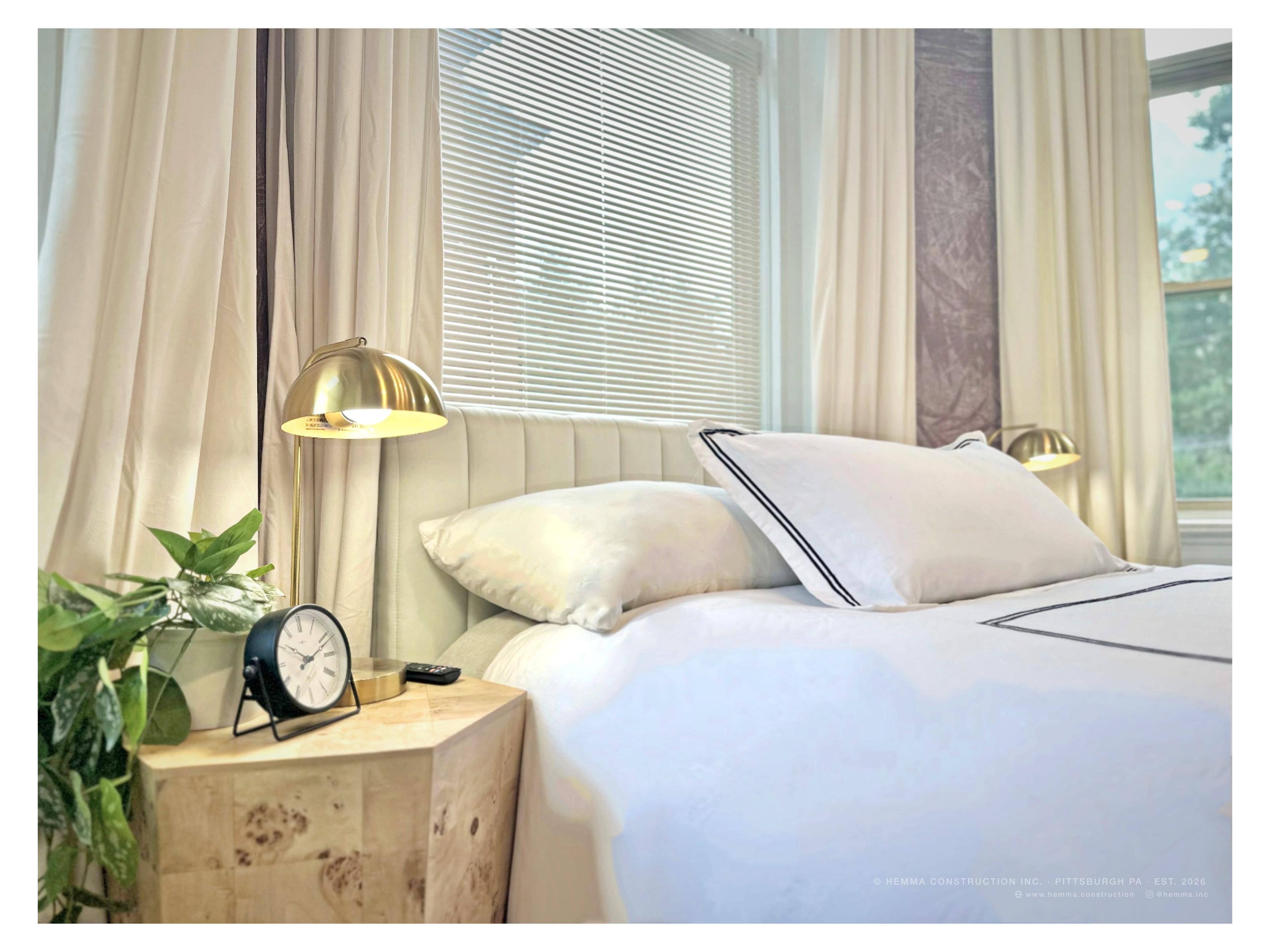 Bedroom close-up — gold dome lamp, channel-tufted headboard, white hotel linen