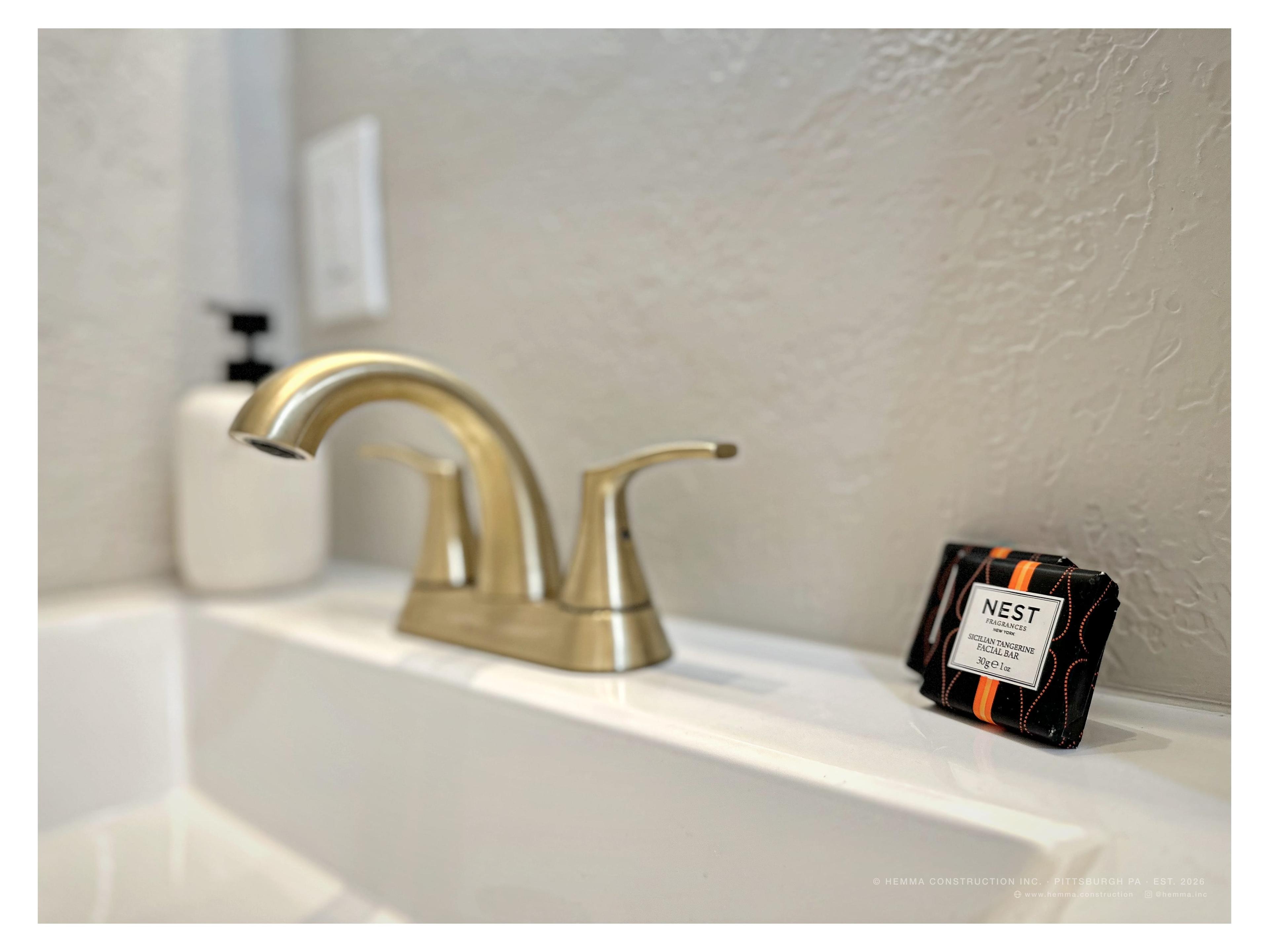Bathroom vanity — gold faucet, Nest soap