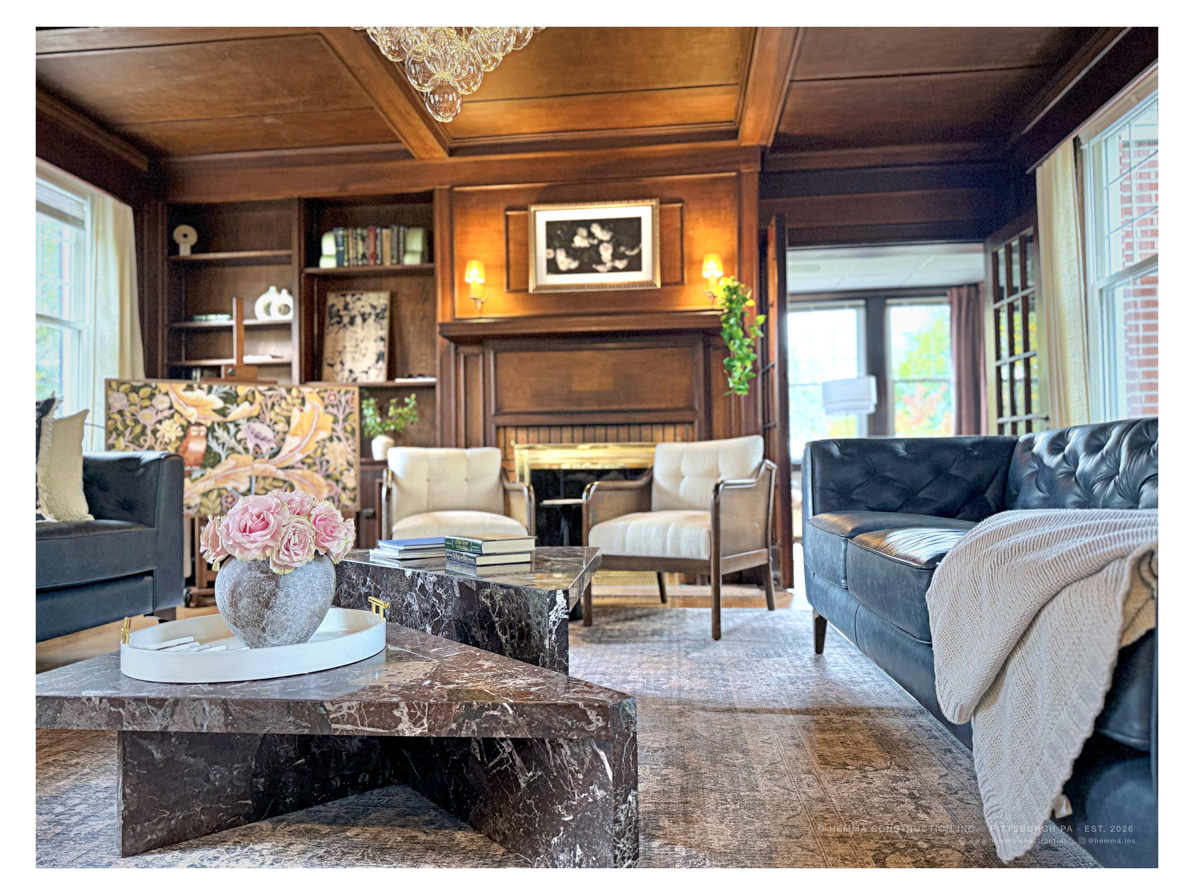 Living room, The Colonial Mt. Lebanon — walnut paneling, original fireplace, marble coffee table
